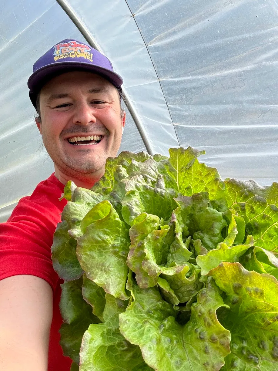 Tyler Morgan hold a head of lettuce